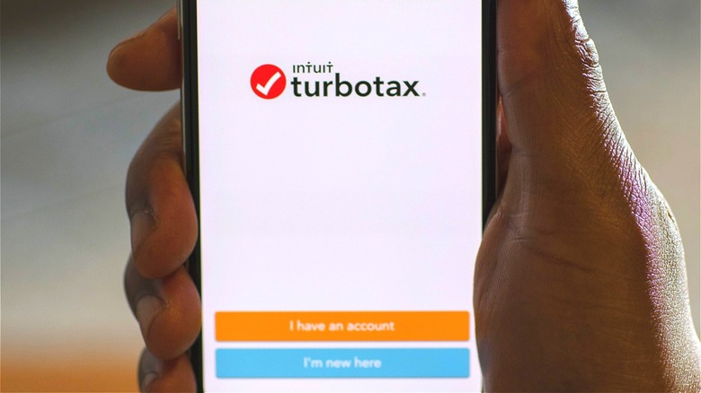 Hand holding TurboTax smartphone app