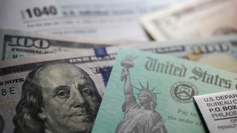 IRS forms, $100 bills and refund check