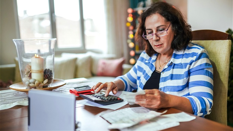 Person calculating finances at home