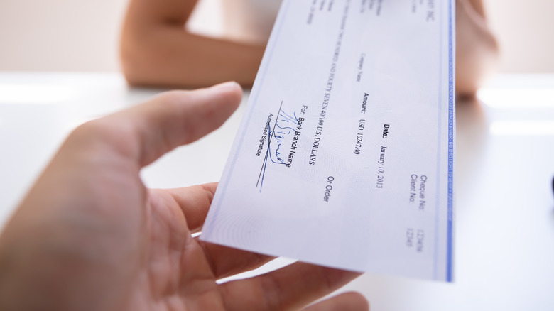 Person handing over cashier's check