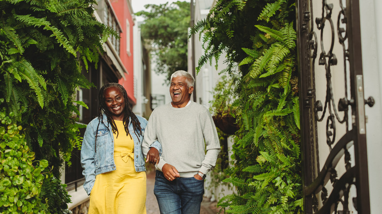 A couple walking on a street looking happy