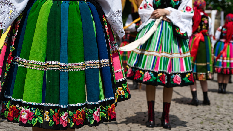 Women dressed in polish national folk costumes from Lowicz region during annual Corpus Christi procession.