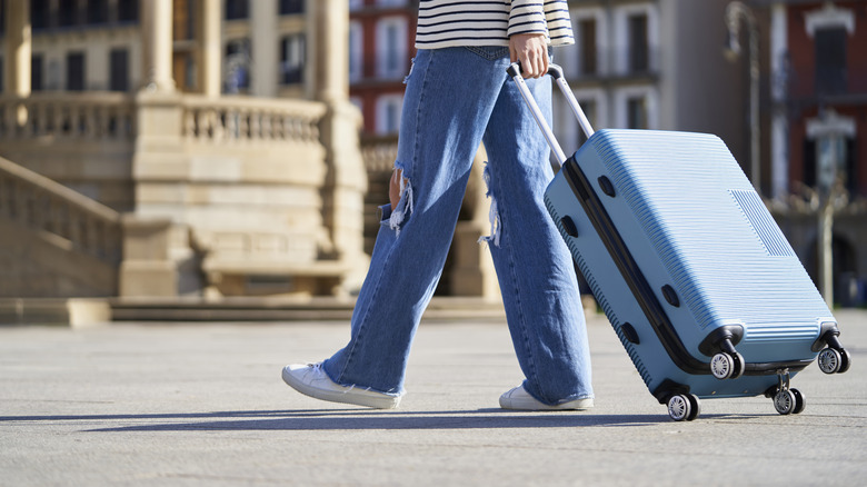 Close-up of a person with a trolley on the street on the way to the hotel