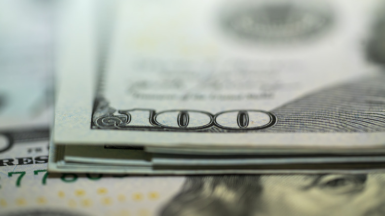 Slightly blurred stack of 100 dollar bills