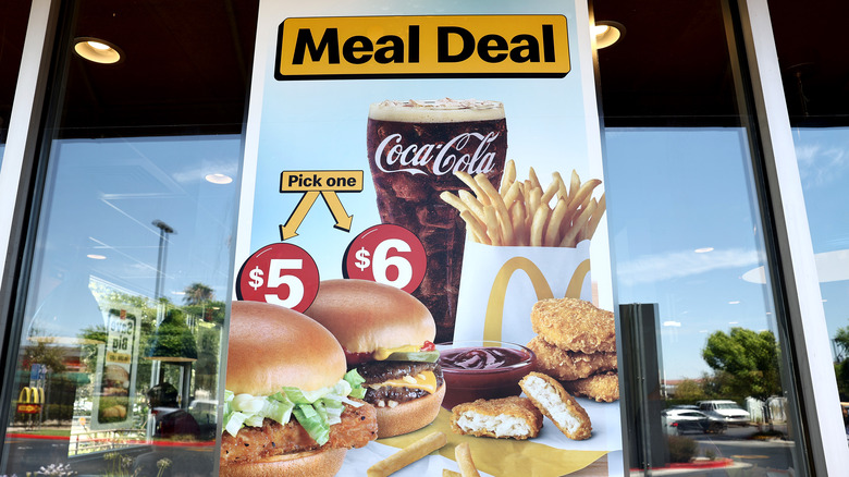 A McDonald's store window displaying a Meal Deal sign