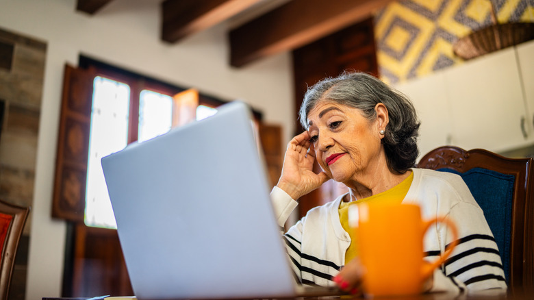 woman looking at computer with a worried look on face