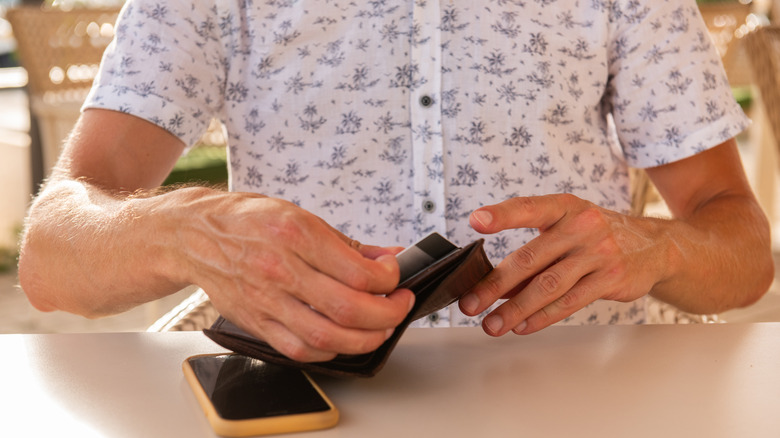 Person pulling card out of wallet