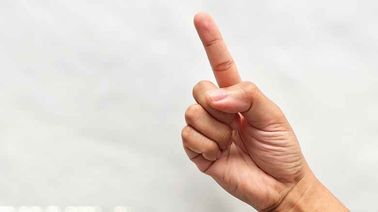 Hand holding up the index finger
