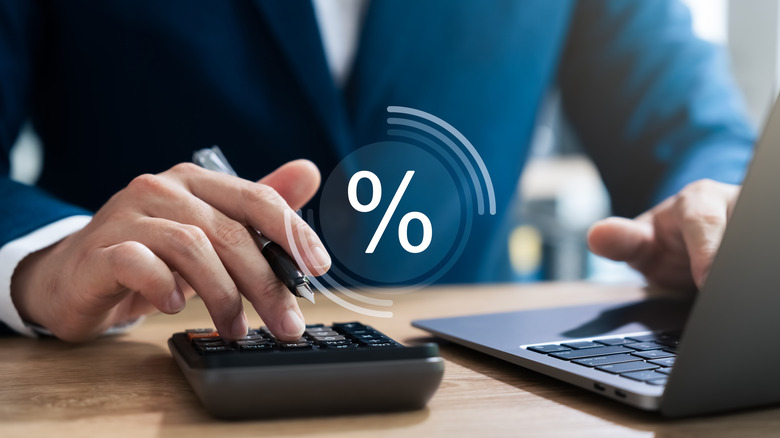 man in suit calculating interest rate