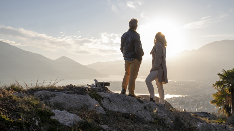 retired couple looking into distance from high viewpoint