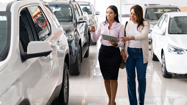 people walking in a car dealership