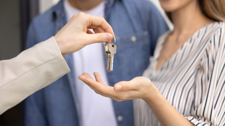 Woman being handed a set of keys