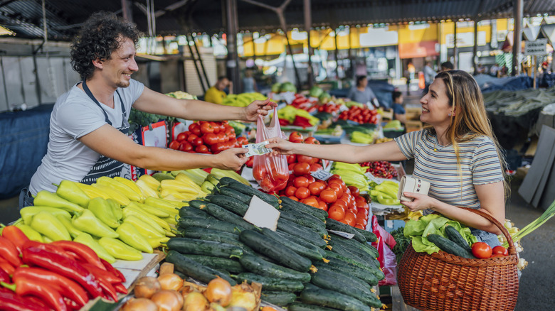 Street seller taking cash from customer