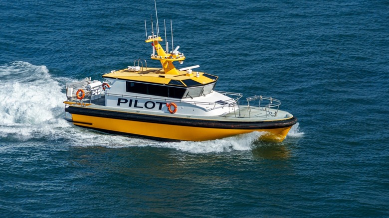 A yellow-and-white boat marked 