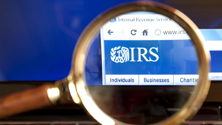 Close up to IRS (Internal Revenue Service) website through a magnifying glass on the laptop