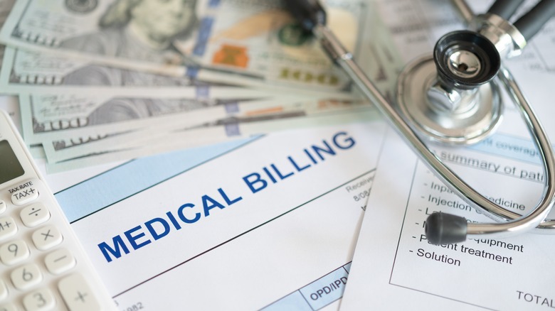a medical bill surrounded by $100 bills