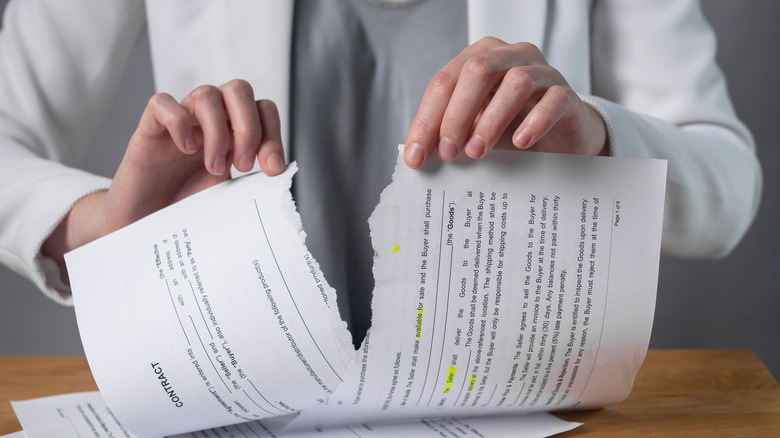 Torn contract in hands