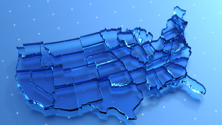 Map of the united states made of clear blue glass sits on top of light blue floor