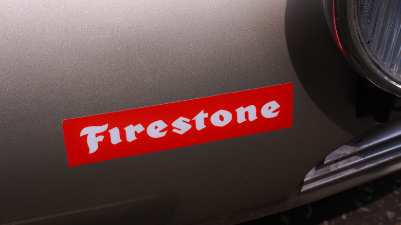 Firestone logo on car body close-up.