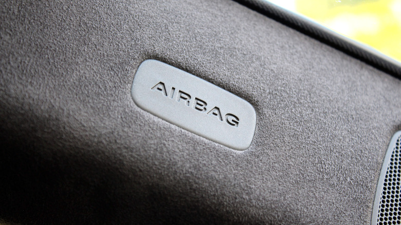 A closeup of an airbag label in a vehicle's interior.
