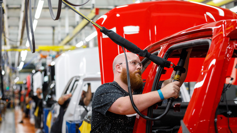 An auto worker on an assembly line working in a GM plant.