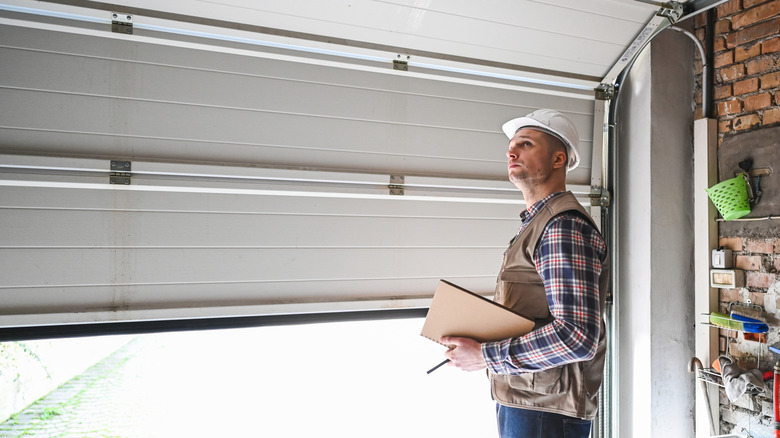 A construction worker inspecting a garage door