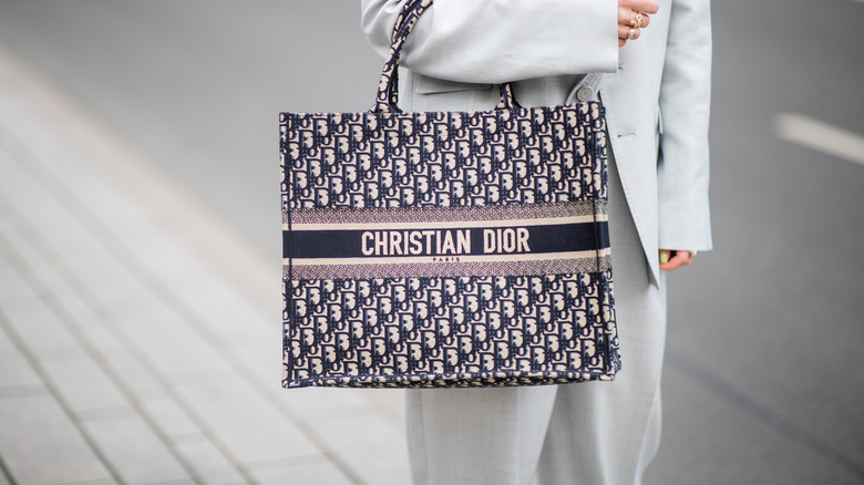 Maria Barteczko is seen wearing grey linen oversized blazer Stella McCartney, grey inen wide leg trousers Stella McCartney, logo book tote bag Dior,