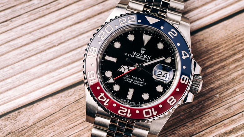 A modern Rolex GMT-Master II wristwatch set down on a board