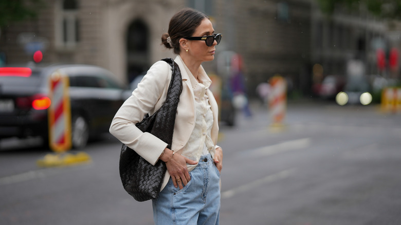 Patricia Wirschke is seen wearing her brown hair in a loose bun with a Bottega Veneta on her shoulder