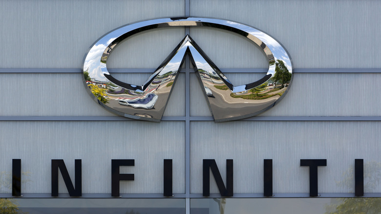Infiniti logo on the facade of car dealer's building.