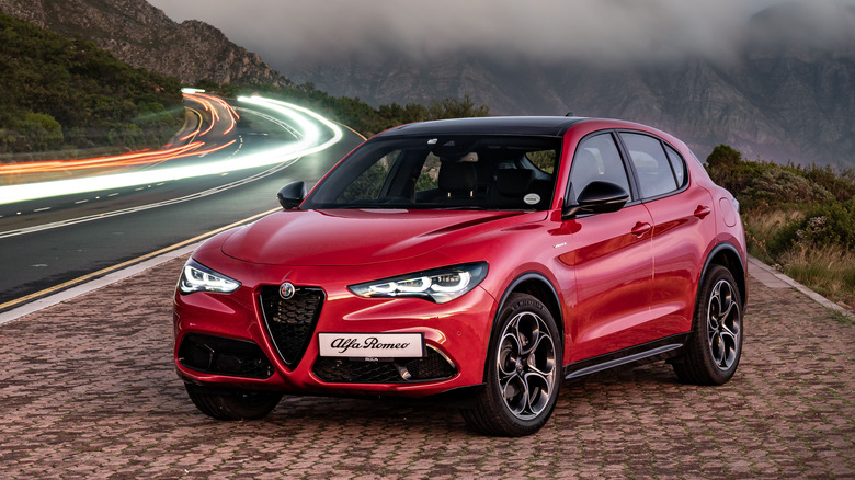 A red Alfa Romeo SUV in a striking image at dusk