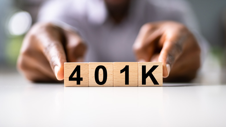 Man with wood blocks spelling out 401k