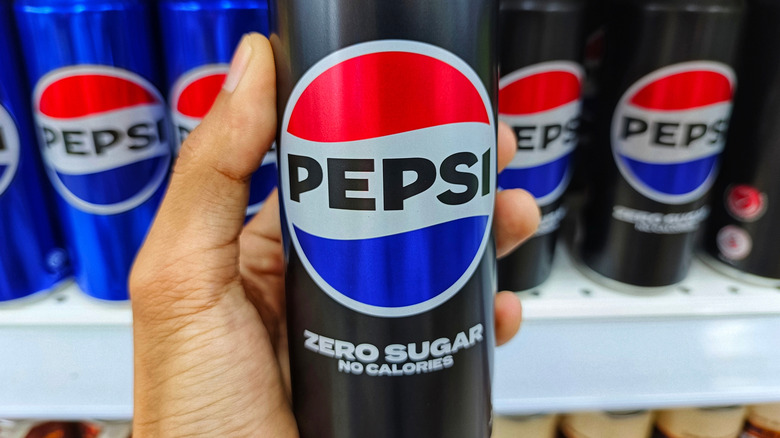 Hand holding a Pepsi zero sugar can