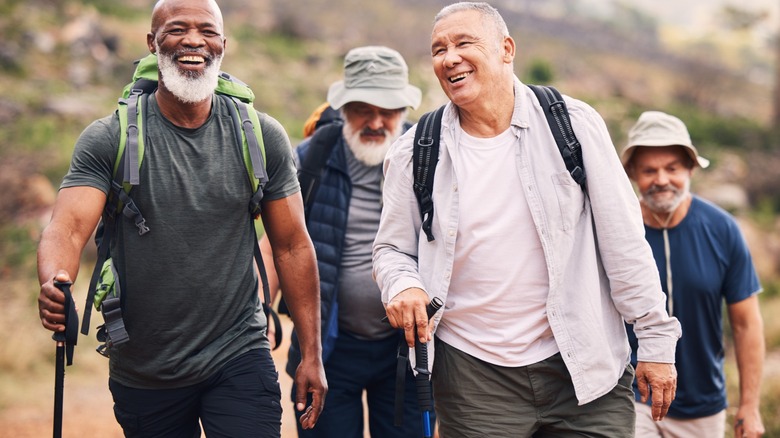 Four senior men trekking