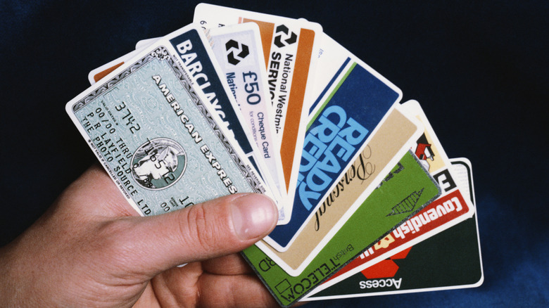 A hand holding credit and other cards in the 1980s
