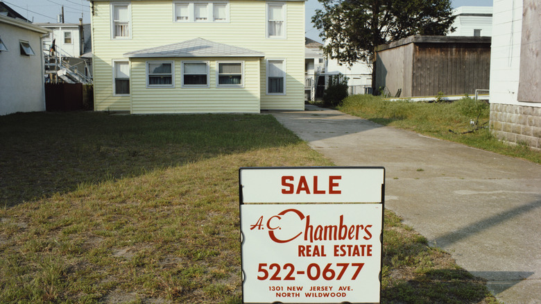 For Sale sign in front of home in 1980s