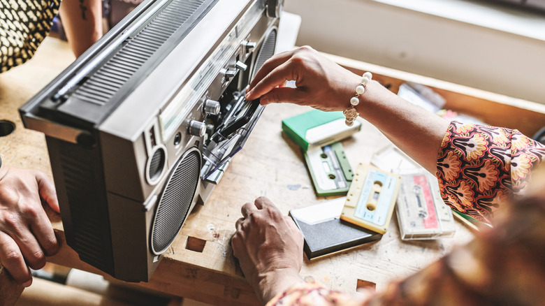 hand starting a tape player