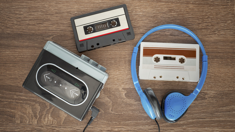 A vintage casette player, tapes, and headphones