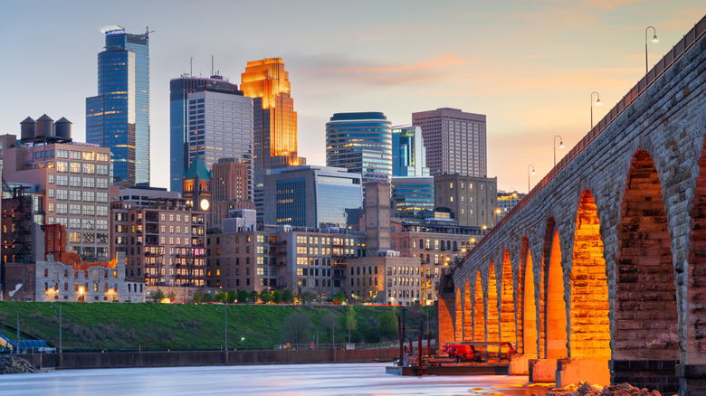 Minneapolis, Minnesota, USA skyline with the Stone Arch Bridge on the Mississippi River at blue hour.