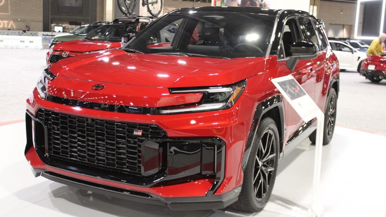 Red 2026 Toyota RAV4 GR Sport-style SUV displayed on an auto show floor