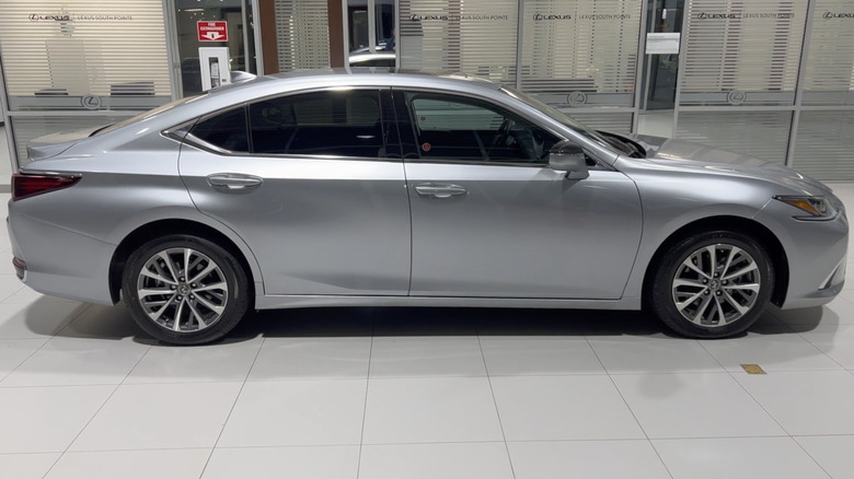 A silver 2022 Lexus ES 250 on display at a Lexus dealership