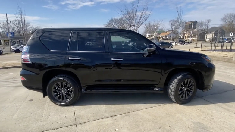 A side view of a black 2022 Lexus GX 460 parked outside on a sunny day