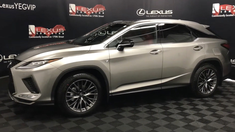 A driver-side view of a 2022 Lexus RX 350 F Sport in a dealership showroom