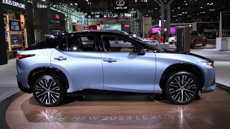 A light blue 2023 Lexus RZ 450e on display at a car show