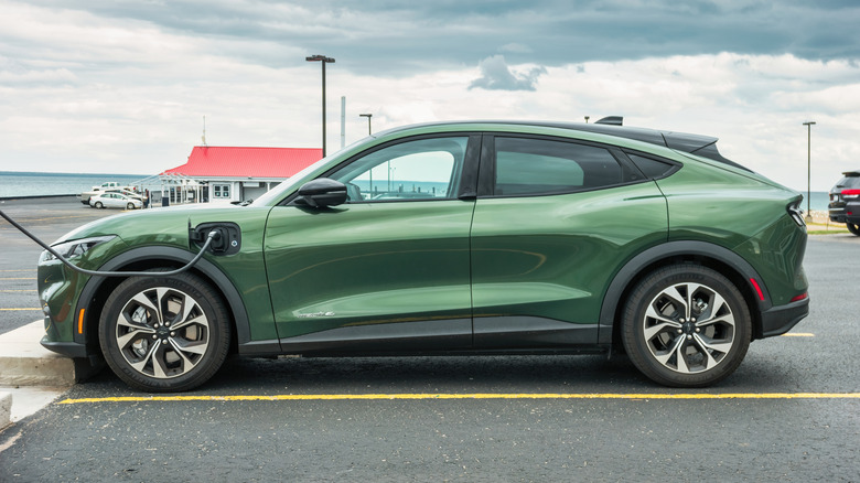 Ford Mustang Mach-E electric car is being charged in Mackinaw City, Michigan, USA on an overcast day.