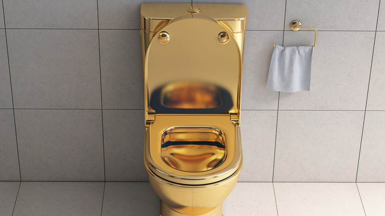 A golden toilet in a bathroom