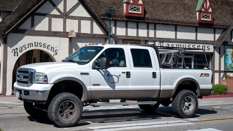 White Ford truck in front of building