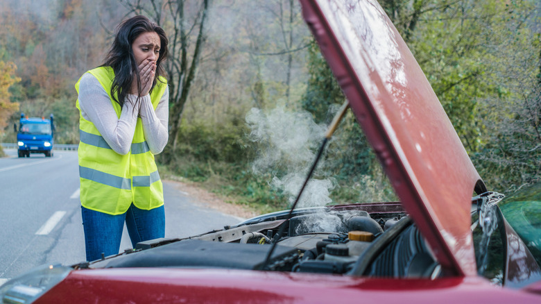woman with smoking car engine