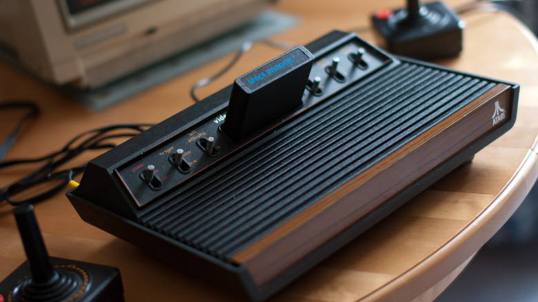 An Atari 2600 sitting on a wood table