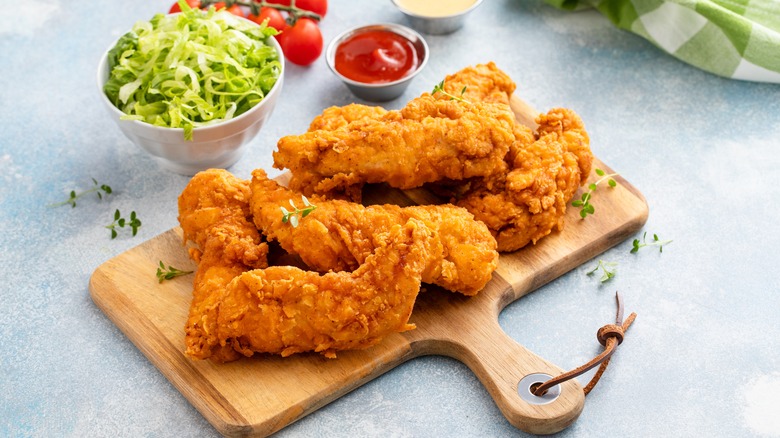 chicken tenders on a board